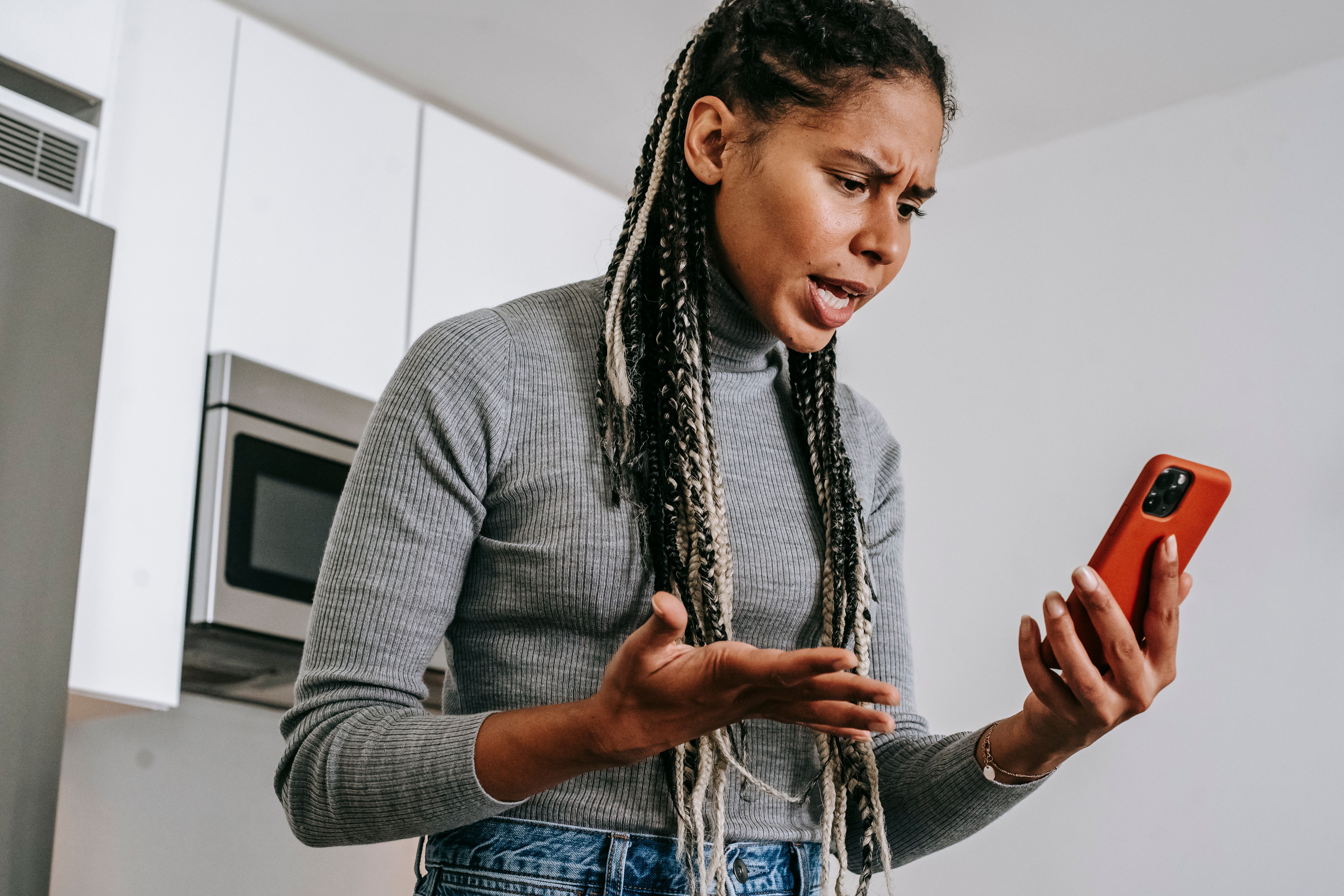 An annoyed woman having a video chat on her smartphone at home