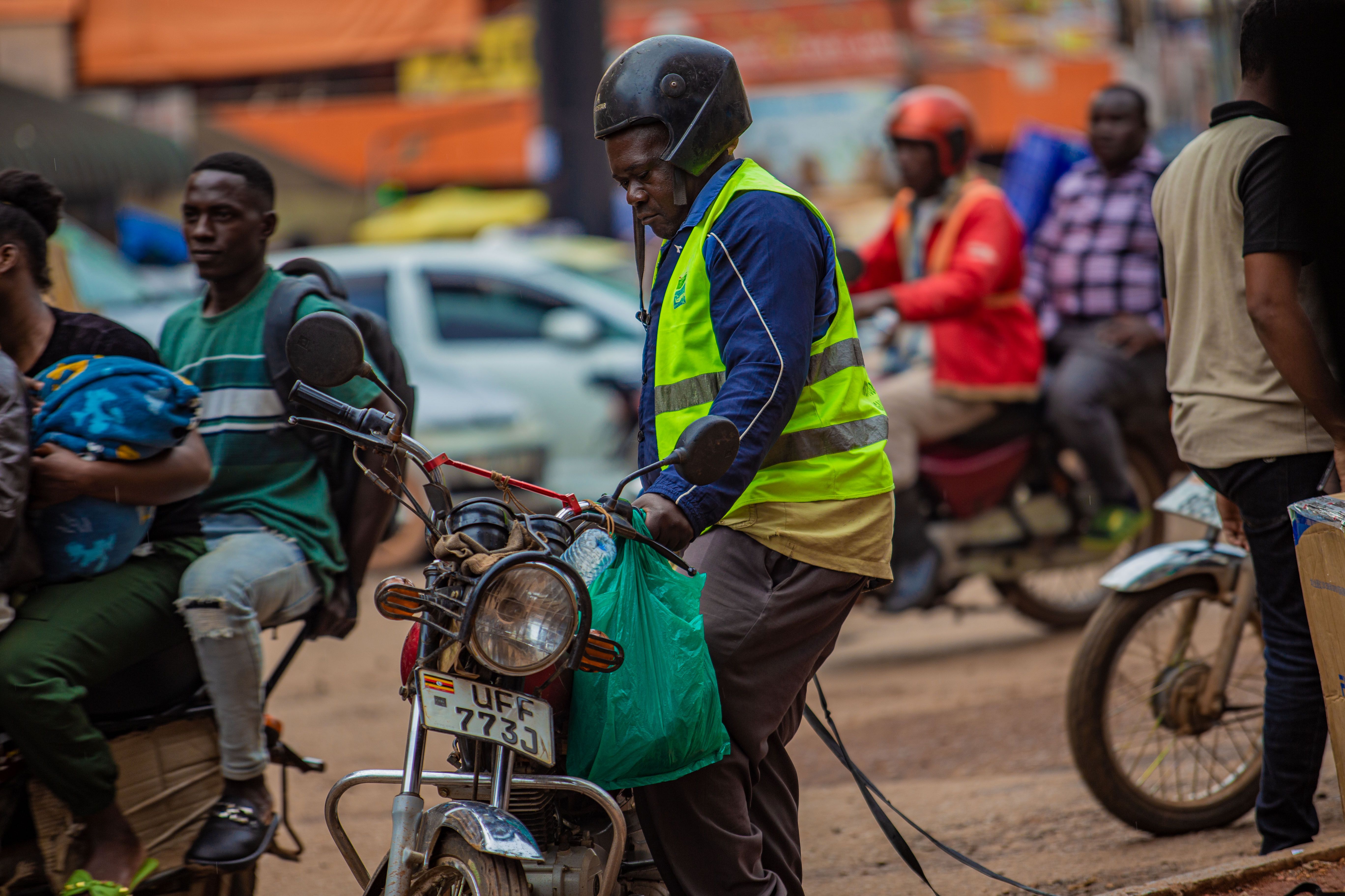 A motorcycle taxi rider on a Ugandan road
