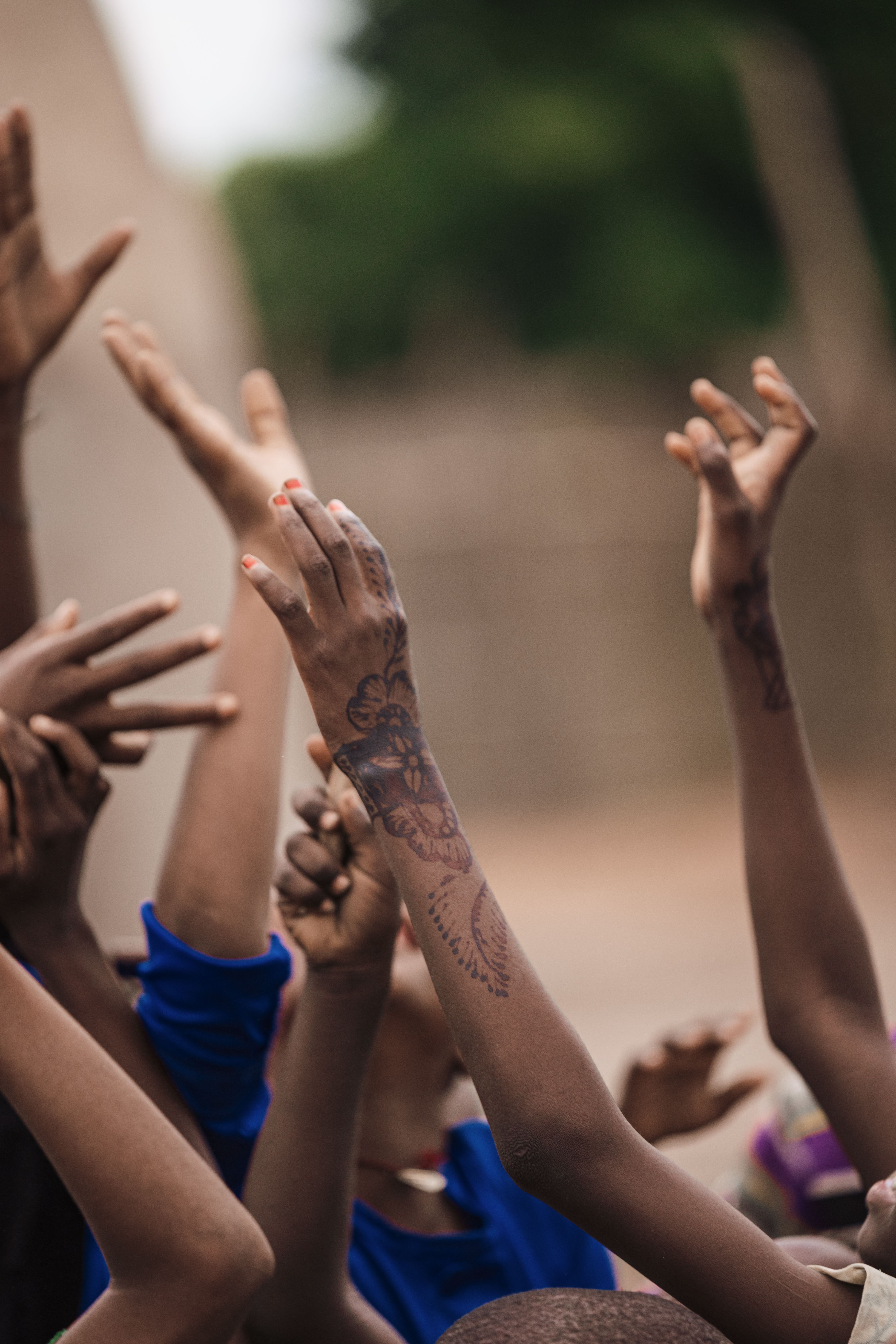 Children with raised hands, joyful and engaged