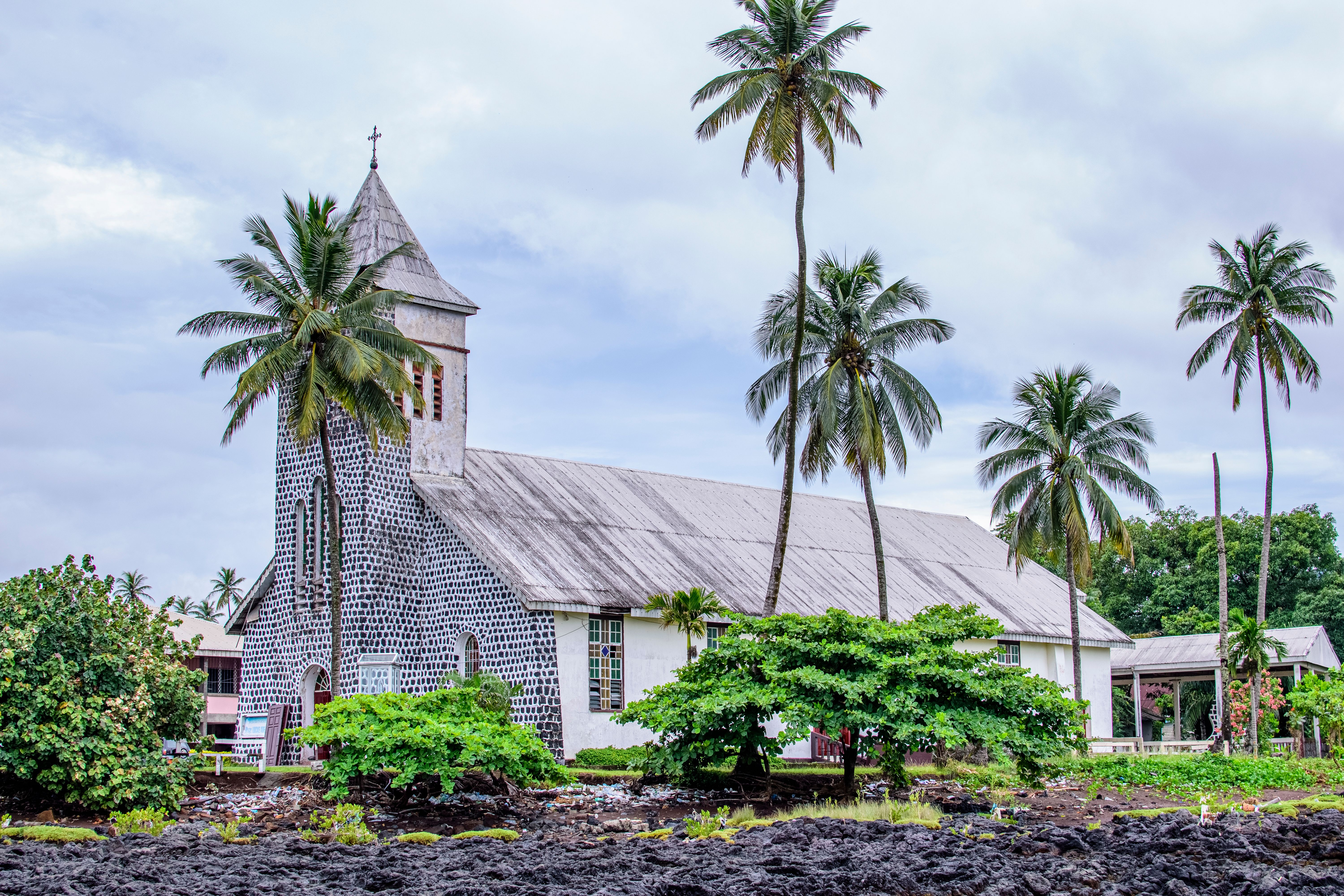 A small church building in a tropical village setting